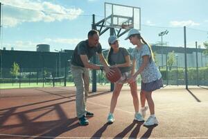 Basketball trainer showing how to shoot basketball to a child . Coach training a kid. photo