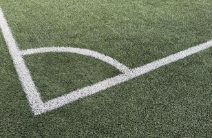 Artificial grass soccer field. Corner kick line of ball and a soccer field , football field , background texture photo