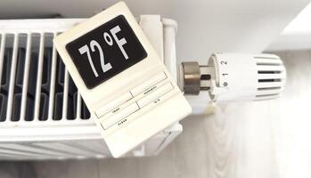 White heating battery and electronic, smart temperature regulator. warmth in the room and the house. preparation for spring and winter. energy saving photo