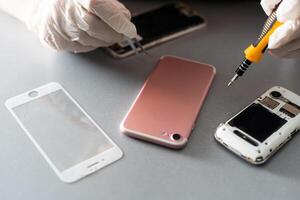 The technician repairing the smartphone's motherboard in the lab with copy space. the concept of computer hardware, mobile phone, electronic, repairing, upgrade and technology. photo