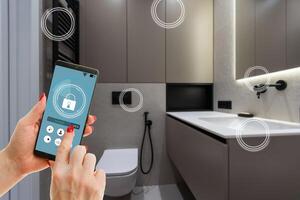 Smart home technology, IoT Internet of Things interface on smartphone app screen connected objects in the modern apartment interior, woman holding device as remote control photo
