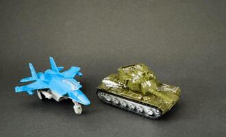 Toy fighter Plane and a toy tank photo
