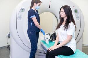 Doctor doing computed tomography for female patient stock photo. Medicine diagnostic concept photo