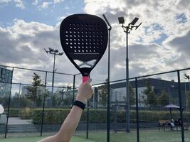 Paddle tennis player racket and ball ready for serve close up anonymous image photo