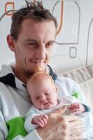 Father and baby boy hugging,little tired dad smiles and rocks the red-haired son to sleep and falls asleep himself too, dads, photo