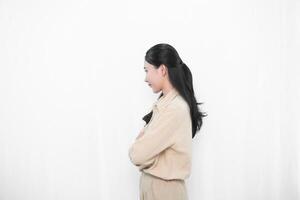 Expression of Indonesian Asian model woman in white dress smiling and folding her arms photo