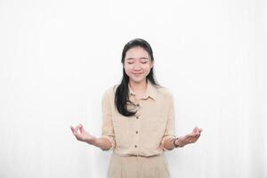 Expression of an Indonesian Asian model woman in white is meditating photo