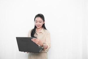 Expression of an Indonesian Asian model woman in white using a laptop photo