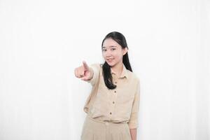 Expression of Indonesian Asian model woman in white dress smiling and pointing forward photo