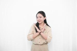 The expression of an Indonesian Asian model woman in white is smiling and making a sign of disagreement. photo