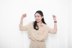 The expression of an Indonesian Asian model woman in white is smiling and making a strong code photo