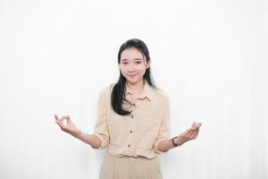 Expression of an Indonesian Asian model woman in white is meditating photo