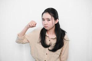 The expression of an Indonesian Asian model woman in white is angry photo