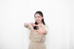 Expression of Indonesian Asian model woman in white dress smiling and making portrait code photo