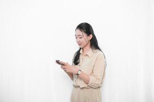 The expression of an Indonesian Asian model woman in white is showing sending a message with a smartphone. photo