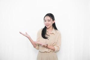 The expression of an Indonesian Asian model woman in white is smiling and giving a signal to invite her. photo