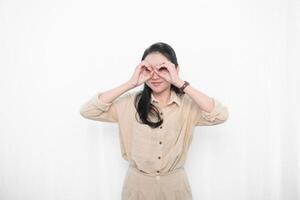 The expression of an Indonesian Asian model woman in a white dress looking forward photo