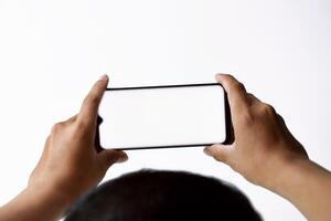 A mans and his hands are using and looking at a mobile smartphone photo