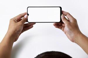 A mans and his hands are using and looking at a mobile smartphone photo