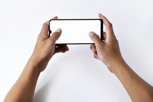 A man's hand is playing with a mobile smartphone with a white screen photo