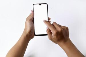 A man's hand is playing with a mobile smartphone with a white screen photo
