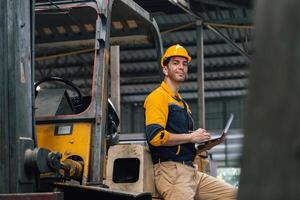 Caucasian engineer using a laptop in a factory. man working in plastics factory. photo