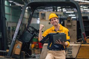 Caucasian engineer using a laptop in a factory. man working in plastics factory. photo
