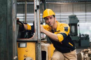 Caucasian engineer using a laptop in a factory. man working in plastics factory. photo