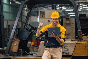 Caucasian engineer using a laptop in a factory. man working in plastics factory. photo