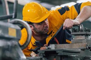 Caucasian engineer using a laptop in a factory. man working in plastics factory. photo