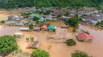 Aerial view of small village in suburb of Chiang Rai flooding by Kok river after typhoon Yagi has swept Southeast Asia. photo
