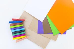 Colored crayons on paper background. photo