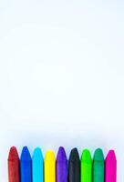 Colored crayons on paper background. photo