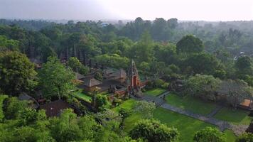 An aerial view of a large green forest and a large building video