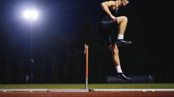 Male Athlete is Running Towards an Obstacle, Hurdling, Jumping Over the Barrier at High Speed while Sprinting in a Race. Cinematic Super Slow Motion video