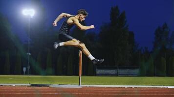Male Athlete is Running Towards an Obstacle, Hurdling, Jumping Over the Barrier at High Speed while Sprinting in a Race. Cinematic Super Slow Motion video
