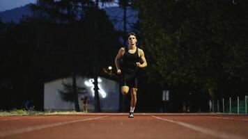 Male Athlete is Running Towards an Obstacle, Hurdling, Jumping Over the Barrier at High Speed while Sprinting in a Race. Cinematic Super Slow Motion video