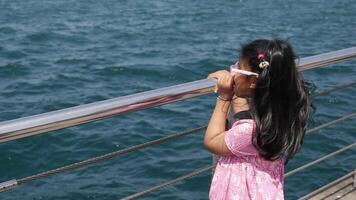A Joyful and Curious Child Happily Enjoying the Beautiful Scenic View by the Peaceful Water video