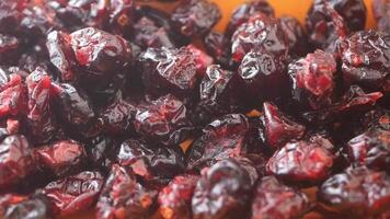slow motion of dried cranberries dropping on a plate video