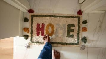 a rug with the word home written on it is on the floor in a hallway video