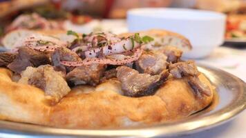 Enjoy a Delicious Lamb Dish That is Served Warm on Flatbread Accompanied by Fresh Garnish video