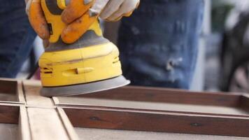 A CloseUp Shot of a Dedicated Woodworker Utilizing a Sander on Their Furniture Project video