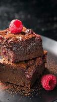 A stack of chocolate brownies with raspberries on top video