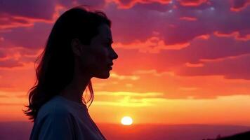 A woman is standing in front of a sunset video