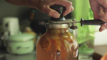 A man rolls up a jar of fruit preserves. video