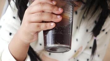 A Child Happily Enjoying a Refreshing Cold Drink While Sitting in a Cozy Cafe Setting video