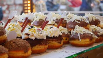 Enjoy a variety of gourmet donuts with various toppings and appealing decorations video