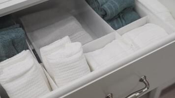 WellOrganized and Neatly Arranged Bathroom Towel Drawer Featuring Soft Plush Towels video