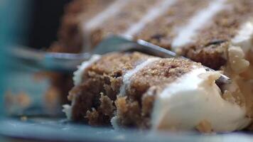A closeup image showcasing a scrumptious carrot cake with creamy cheese frosting video