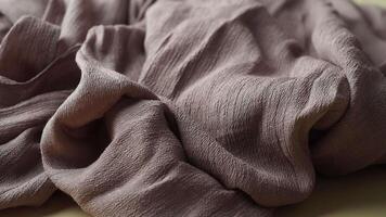 This is a soft and textured fabric presented in a range of beautiful earthy tones video